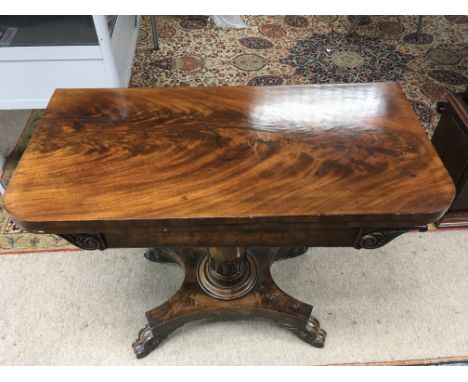 A swivel Victorian mahogany card table with carved base, some damage - cracking to veneer and base.