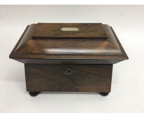A rosewood tea caddy with mother of pearl inlay and lion mask handles to each side.