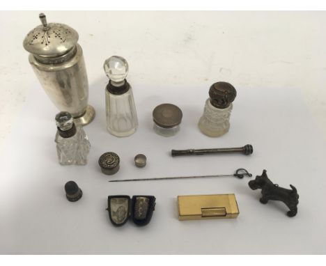 A silver sugar caster, thimbles and other silver oddments, together with a gold tone Dunhill lighter.