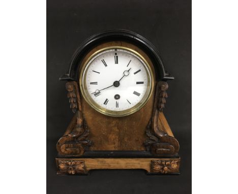 An Edwardian small carved walnut mantel clock with enamel dial