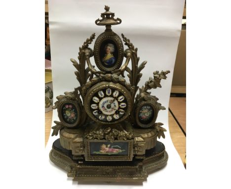 An 18th Century painted enamel and giltwork 8 day mantle clock with panels depicting a cherub, a female figure and flowers, a