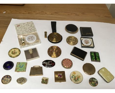 A collection of vintage compacts including a USA Volupte and Stratton