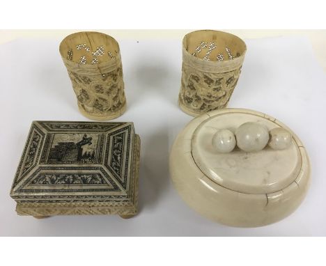 An antique ivory oval shaped trinket box, a small pair of ivory brush pots, a/f and a bone Grand Tour casket  box