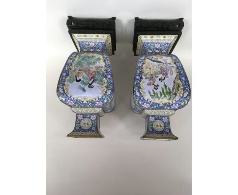 A large pair of 20th century oriental enamel vases decorated with ladies and flowers, on carved wood bases.Approximately 61cm