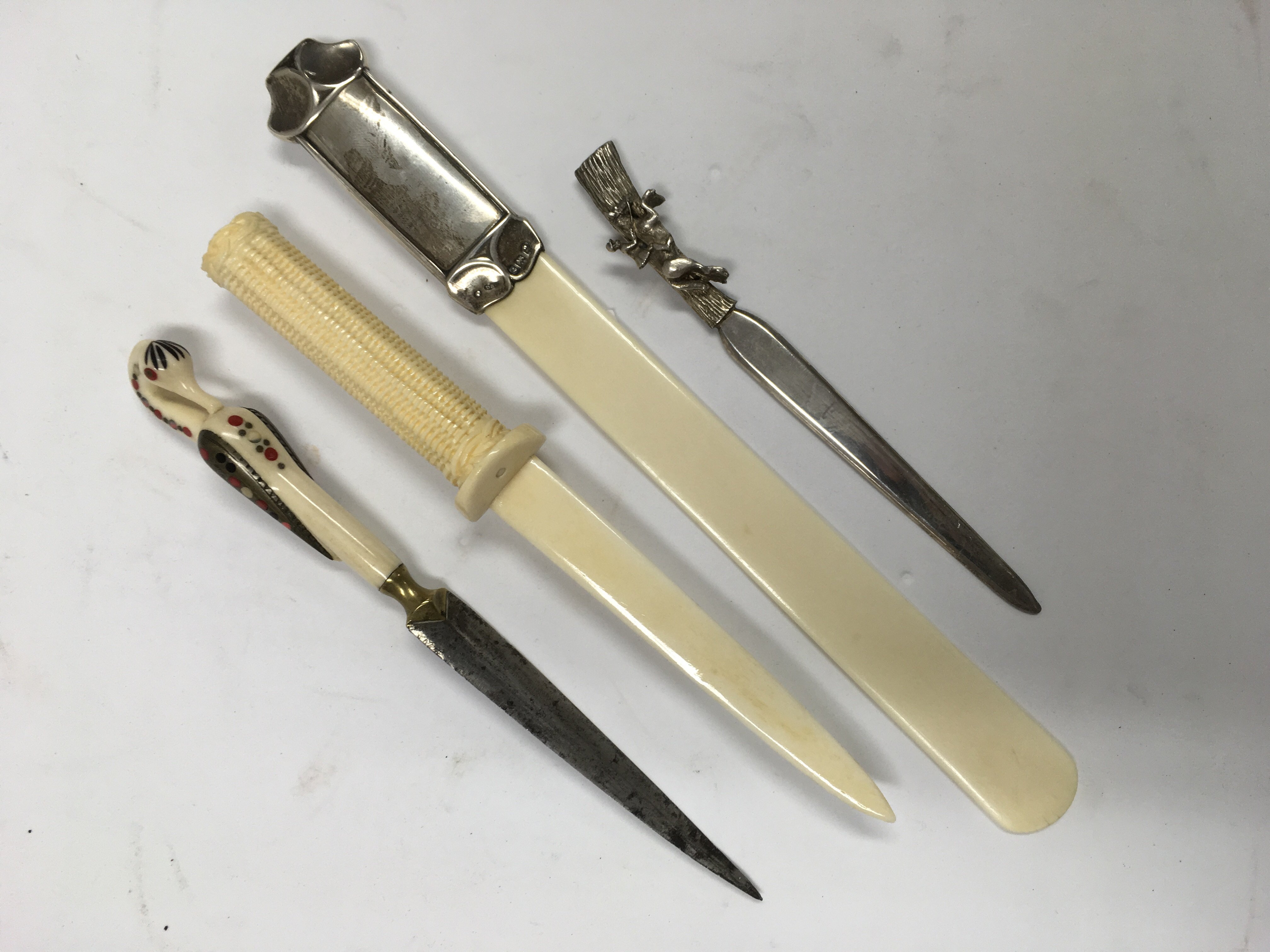 An ivory paper knife with silver mounts, a a Japanese ivory paper knife