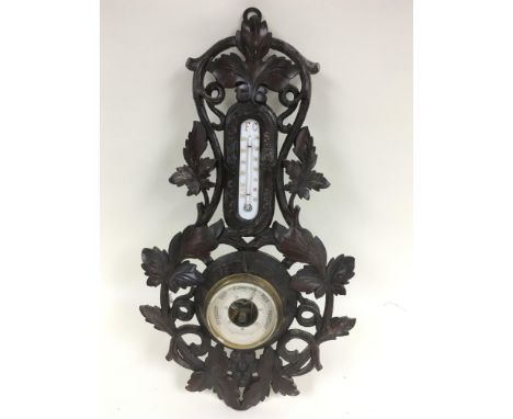 A Black Forest carved wood barometer