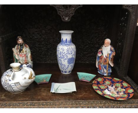 A small group of oriental ceramics including a pair of immortal figures and enamel dishes, a/f