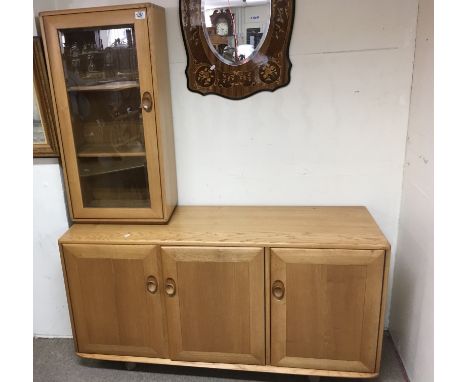 An Ercol light wood sideboard with fitted shelf interior and narrow display cabinet.Approximate length of sideboard 135cm, he