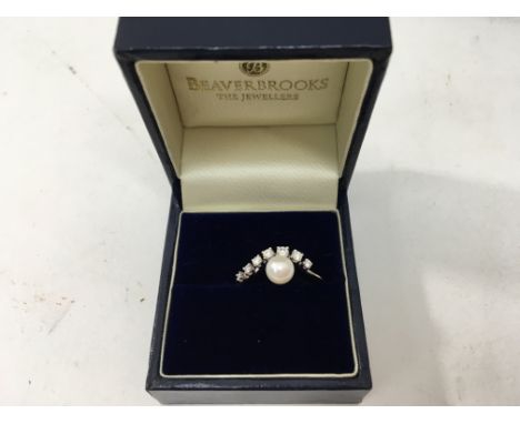 An unmarked pearl and diamond ring.