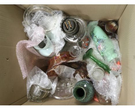 A box of glass including a Victorian glass oil lamp, jelly mounds, carnival glass and decanters