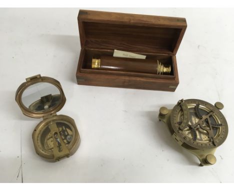 A reproduction sextant, compass and telescope.