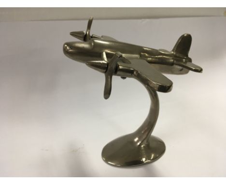 Vintage model aeroplane (aluminium) on raised base with two propellers