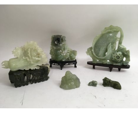 A collection of six jade carvings including a large fish, approximately 9x10  inches, a large flower 8x5 inches and a monkey 