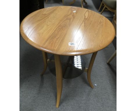 An Ercol light wood occasional table with glass under shelf