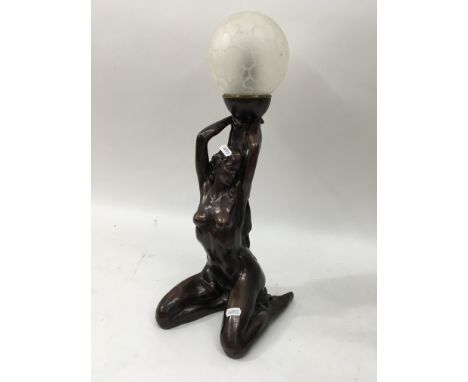 A reproduction Art Deco style lamp of a nude maiden.