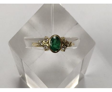 An 18ct gold, emerald and diamond ring, approx size R and 4.2g.