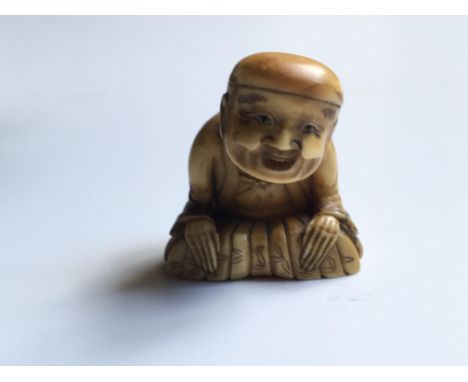 A Japanese carved Ivory Netsuke of the Meiji period 19th Century, in the form of an elder with a dding head, base, 3.8cm