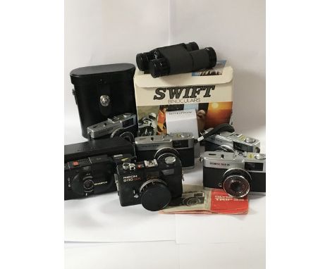 A collection of vintage cameras including Four Olympus trip 35,a pair of swift binoculars and other cameras.