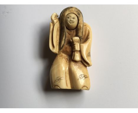 A Japanese carved Ivory Netsuke of the Meiji period 19th Century. The figure with a revolving face, signed base 5cm.