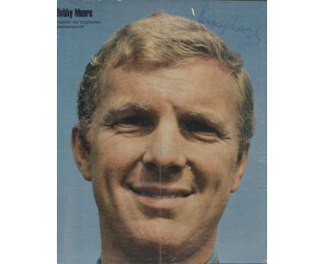 Bobby Moore signed 11x9 inch colour magazine vintage photo. Good condition. All autographs are genuine hand signed and come w
