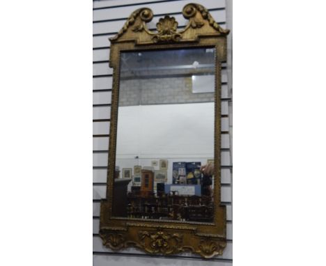 Victorian gilt mirror with scroll top and shell finial, floral skirt, 92cm 
