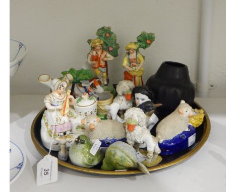 19th century spill vase modelled as a lady seated with a stringed instrument, with tree trunk behind, a pair of Staffordshire