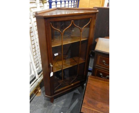 Mahogany-finish dwarf standing corner display cupboard enclosed by bi-glazed door, 63cm wide, a modern reproduction four-draw