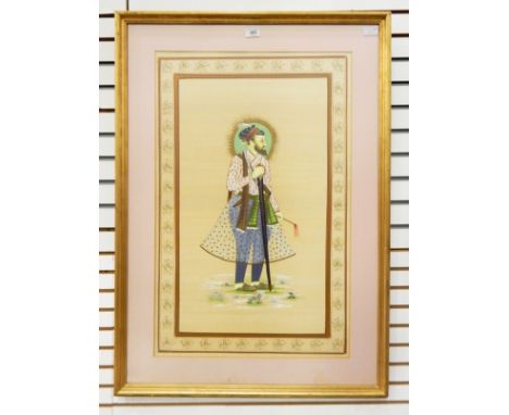 Persian school, early 20th centuryOil on silk Portrait of a man holding a sword within a gold foliate border, 79cm x 50cm 