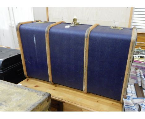 A canvas and wood bound blue school trunk, two black metal tin trunks and a large tin travelling trunk (4)
