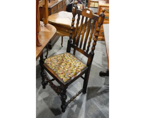 Set of four oak framed dining chairs with bobbin turned supports and loose trap seats and pair of oak carver chairs, rail bac