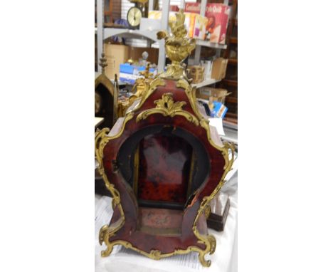 Faux-tortoiseshell clock case with ormolu scrolling mounts and surmounted by a basket of flowers with sunburst pendulum and e