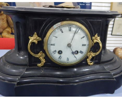 A Victorian slate mantel clock, the circular enamel dial with Roman numerals, the case of shaped oval form with applied gilt 