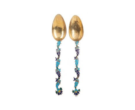 PAIR OF SCANDINAVIAN SILVER GILT AND CHAMPLEVE ENAMEL TEASPOONS,the handles formed as a series of fish, hammered effect to bo