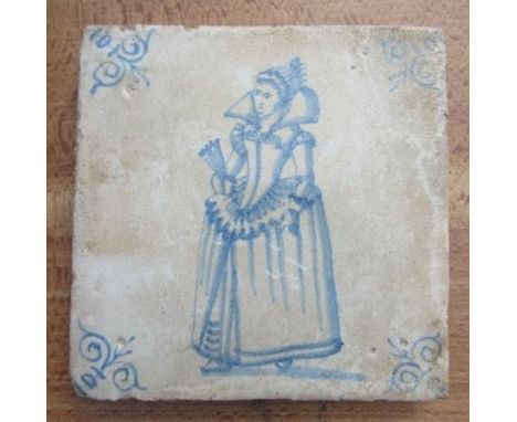 A Delft style pottery tile, decorated with a woman in period dress, 5ins x 5ins