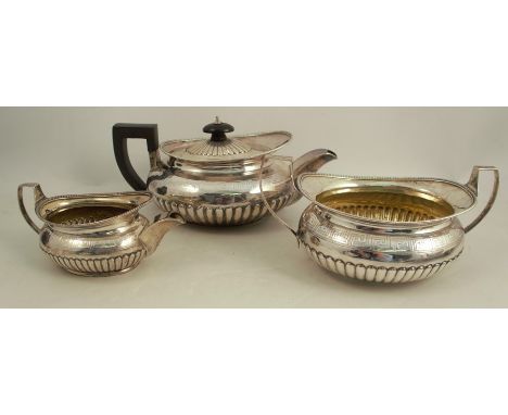 A Georgian silver three piece tea set, with gadrooned lower body and engraved decoration, London 1805, maker R &amp; S Hennel