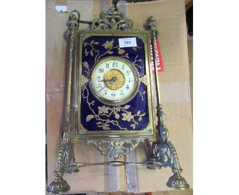 A 19th century Aesthetic movement mantel clock. the movement with enamel chapter ring set in a rectangular porcelain plaque d