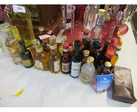 A group of miniatures spirits and a bottle of tequila