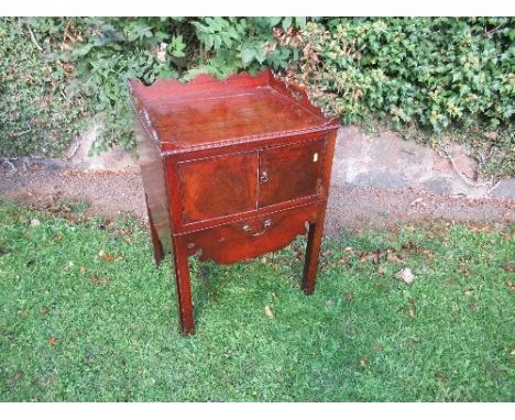 A 19th century mahogany tray top commode, with cupboard below, on brass castors, 22ins x 19ins x height 30.5ins