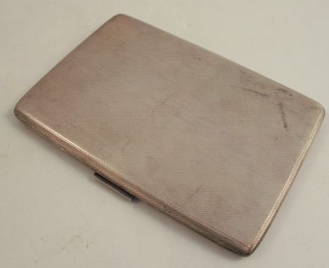 A hallmarked silver cigarette case, of rectangular form with engine turned decoration, weight 5oz