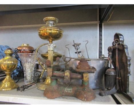 A collection of metalware, to include oil lamps, scales, fire tools, spirit kettle etc