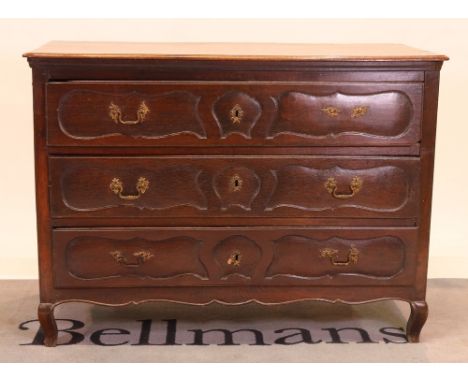 A late 19th century french oak commodeWith three long drawers on cabriole supports, 126cm wide; 96cm high