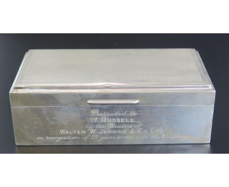 An Elizabeth II silver cigarette box, maker S J Rose &amp; Son, Birmingham, 1960, inscribed, of rectangular outline with engi