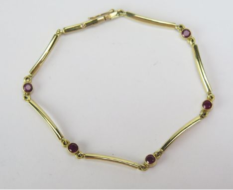 An 18ct Gold and Ruby Bracelet with five c. 2.95mm rub over set stones, London hallmarks, 6.75" (17cm), 5.04g 