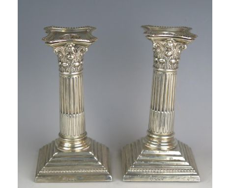 A pair of George V silver Corinthian candlesticks, maker William Hutton &amp; Sons Ltd, Sheffield, 1925, with stop fluted col