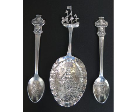 A continental silver caddy spoon, bears import marks, the bowl decorated with a farming girl with sailing boat terminal, 12cm