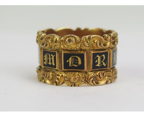 A William IV Gent's 18ct Gold and Enamel Memorial Ring with ten black panels spelling "IN MEMORY OF" and shouldered by scroll