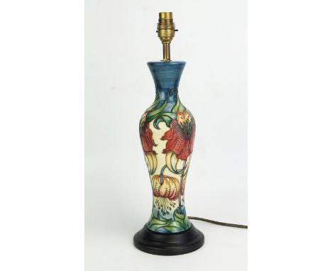 A Moorcroft pottery table lamp, of baluster form with Anna Lilly pattern decoration, mounted on a polished wood base, 34cm hi