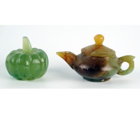 A polished jadeite miniature teapot and cover, 8cm long, together with a model of a pumpkin. 
