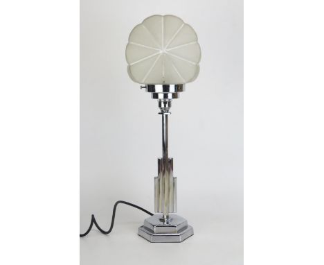 An Art Deco style chrome table lamp, with shell-shaped frosted glass shade raised on a polygonal multi-stem on a stepped hexa