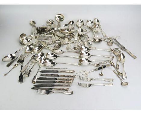 A collection of silver handled butter knives, silver plated flatwares, pickle fork, serving spoons etc 